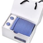 Stylish blue striped men's tie, matching cufflinks, and fabric in a sleek white gift box, perfect for groomsmen or formal occasions, with luxury branding by Deo Veritas.