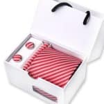 Elegant red and white striped gift set including cufflinks, tie, and pocket square, presented in a sleek white box, perfect for formal occasions and gifting.