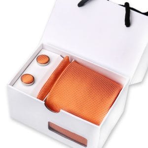 Luxurious orange silk pocket square and cufflinks set in elegant white gift box, perfect for men's fashion accessories and gift-giving.