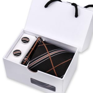 Striped black, white, and brown men's accessories gift set with tie, pocket square, and cufflinks in white box.