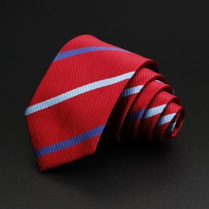 Vibrant red men's necktie with diagonal light blue and dark blue stripes, neatly rolled on a black background, ideal for formal or professional attire, showcasing high-quality fabric and stylish design.