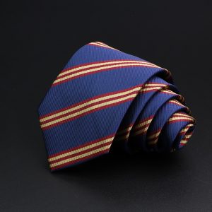 Vivid blue and red striped men's necktie, diagonally folded on dark background, showcasing elegant formal accessory for professional and wedding attire.