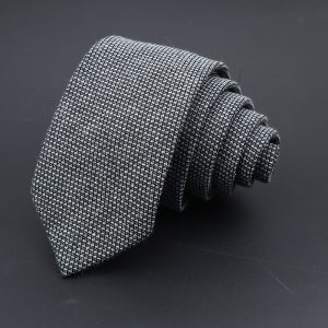 Fine black and white patterned men's dress necktie, versatile accessory for formal and professional occasions.